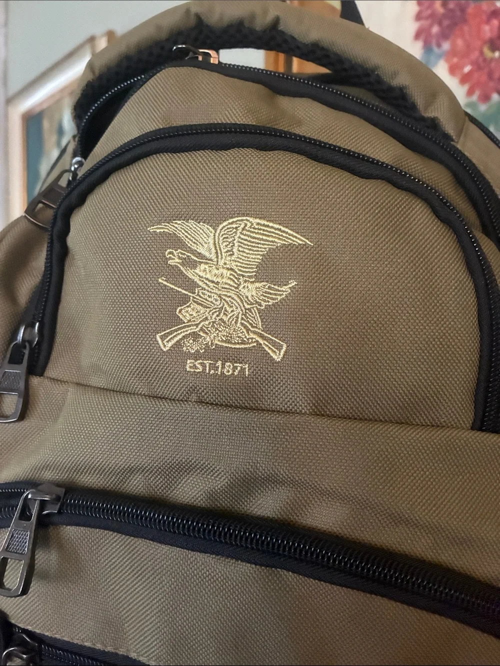 NRA Tactical Backpack Multi-Pocket in tan with black accent panels, EST 1871